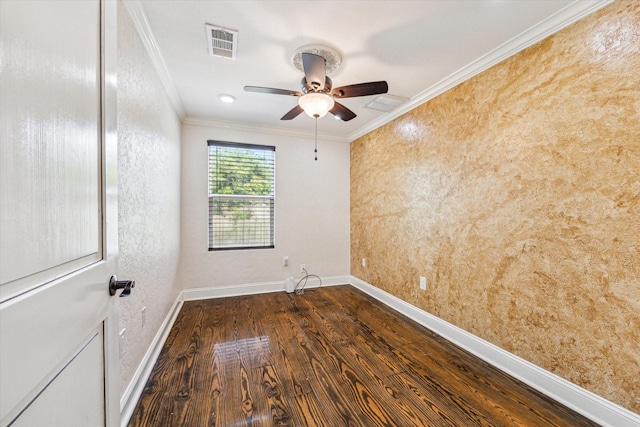 spare room featuring a ceiling fan, visible vents, ornamental molding, and dark wood-style flooring