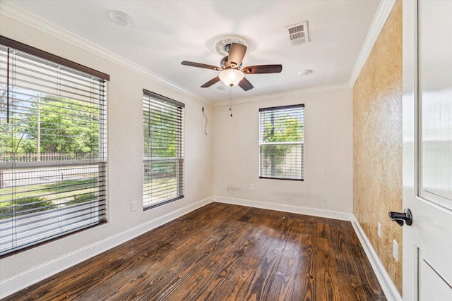 empty room with hardwood / wood-style floors, visible vents, ornamental molding, baseboards, and ceiling fan