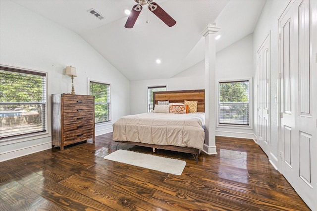 bedroom featuring lofted ceiling, baseboards, wood finished floors, and visible vents