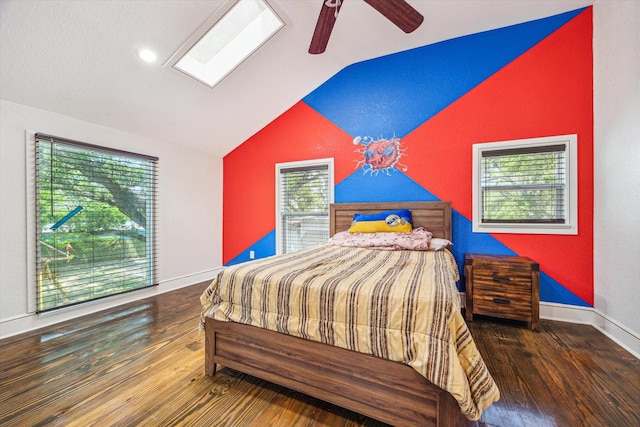bedroom featuring baseboards, vaulted ceiling with skylight, and wood finished floors