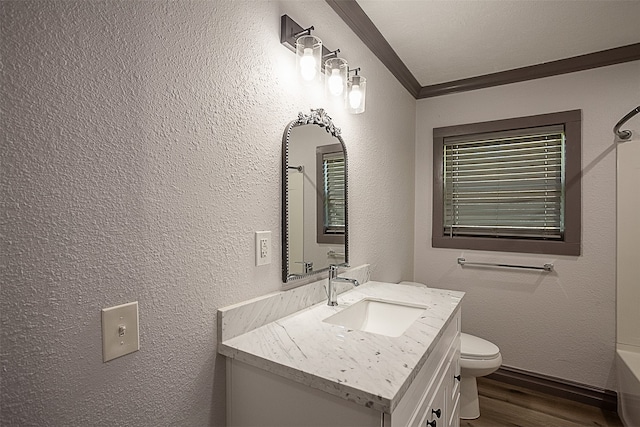 559 Doty Rd, Vidor, TX 77662 - bathroom featuring toilet, a washtub, wood finished floors, vanity, and ornamental molding