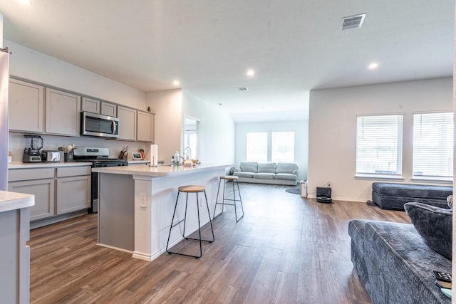 24737 Mountain Tree Dr, Magnolia, TX 77355 - kitchen with visible vents, appliances with stainless steel finishes, open floor plan, and gray cabinetry