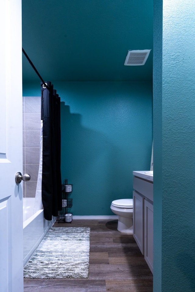 24737 Mountain Tree Dr, Magnolia, TX 77355 - bathroom with shower / bath combination with curtain, wood finished floors, visible vents, toilet, and vanity