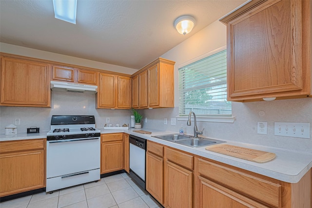215 Pebble Canyon Ln, Dickinson, TX 77539 - kitchen featuring white appliances, a sink, under cabinet range hood, light countertops, and light tile patterned flooring