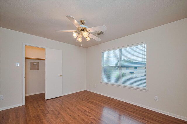 215 Pebble Canyon Ln, Dickinson, TX 77539 - empty room with wood finished floors, ceiling fan, and baseboards