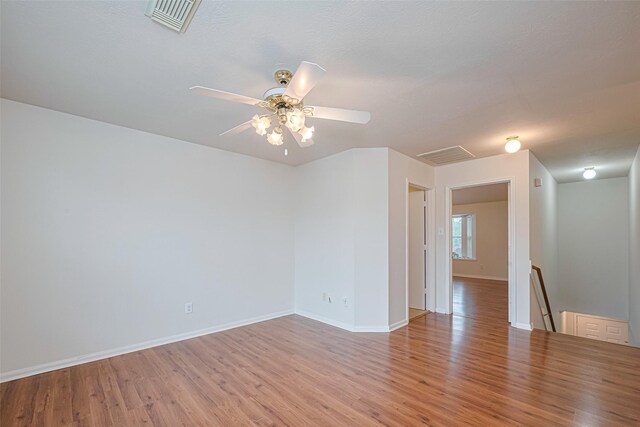 215 Pebble Canyon Ln, Dickinson, TX 77539 - empty room featuring light wood-style flooring, baseboards, and ceiling fan