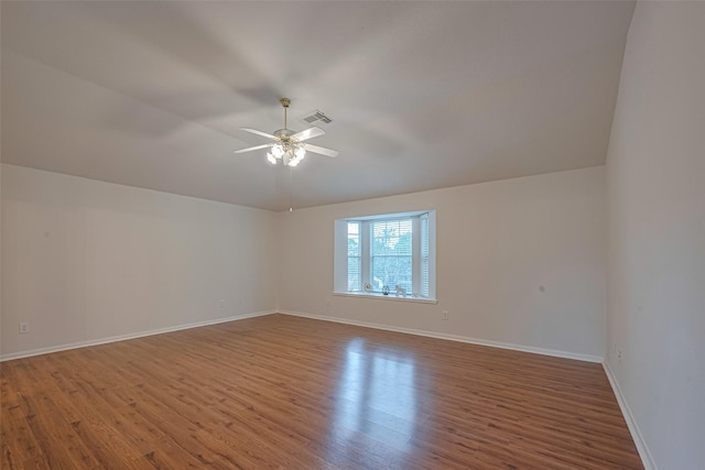 215 Pebble Canyon Ln, Dickinson, TX 77539 - empty room with wood finished floors, ceiling fan, baseboards, and vaulted ceiling
