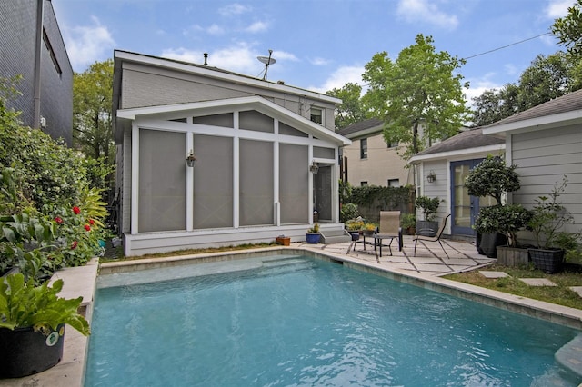 pool featuring a patio area and a sunroom