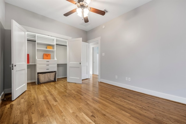 unfurnished bedroom featuring a ceiling fan, baseboards, visible vents, and light wood-type flooring