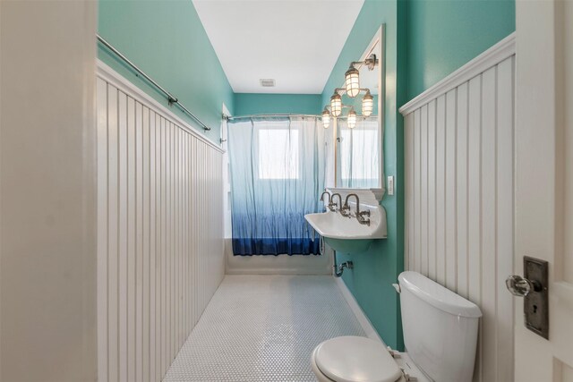 bathroom with tile patterned flooring, toilet, and visible vents