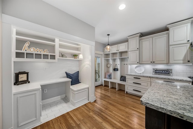 mudroom featuring light wood-style floors and baseboards