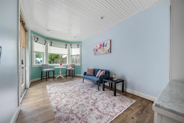 sitting room with baseboards and wood finished floors
