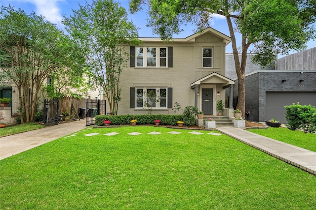 traditional-style house featuring fence, driveway, and a front lawn