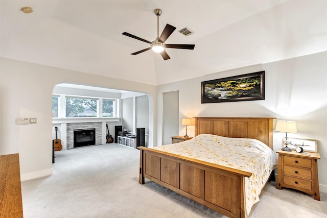 bedroom featuring baseboards, visible vents, a tile fireplace, and light colored carpet