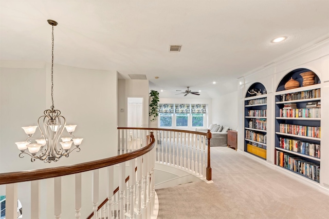 hall with visible vents, built in features, recessed lighting, carpet, and an upstairs landing