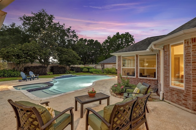 view of swimming pool with a patio, a pool with connected hot tub, and a fenced backyard