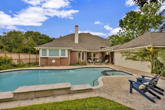 view of pool with a fenced in pool, an in ground hot tub, fence, and a patio