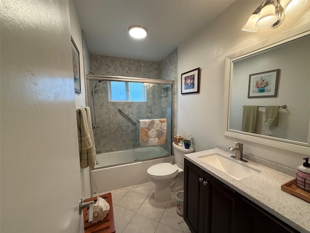 bathroom with vanity, tile patterned floors, toilet, and shower / bath combination with glass door