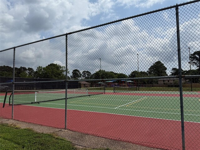 view of sport court featuring fence