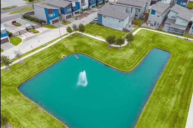 drone / aerial view with a residential view and a water view