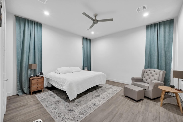 bedroom with a ceiling fan, visible vents, wood finished floors, and recessed lighting