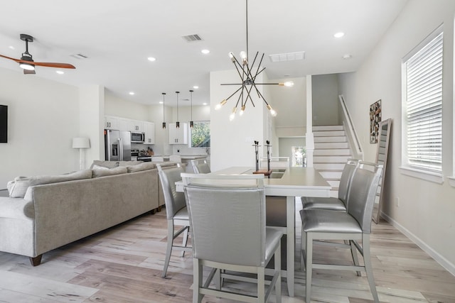 dining area with stairway, recessed lighting, visible vents, and light wood-type flooring