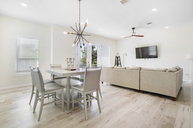 dining area featuring ceiling fan with notable chandelier, light wood finished floors, baseboards, visible vents, and recessed lighting