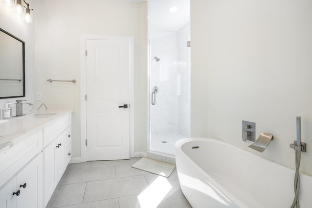 bathroom with vanity, a freestanding bath, tile patterned flooring, and a stall shower