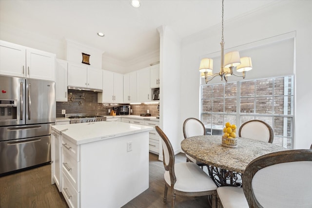 2842 Briarhurst Park, Houston, TX 77057 - kitchen with an inviting chandelier, a kitchen island, decorative backsplash, stainless steel fridge, and range