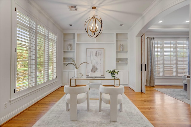 dining area featuring plenty of natural light, visible vents, built in features, and a notable chandelier