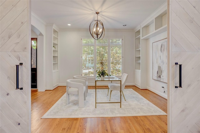 dining room featuring wood finished floors, built in features, and ornamental molding