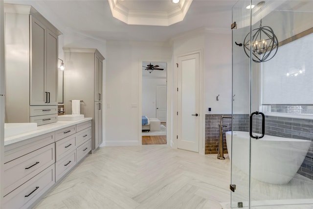 full bathroom with vanity, crown molding, a soaking tub, ensuite bathroom, and ceiling fan with notable chandelier