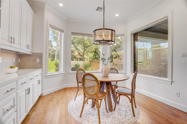 dining room with baseboards, a wealth of natural light, visible vents, and an inviting chandelier