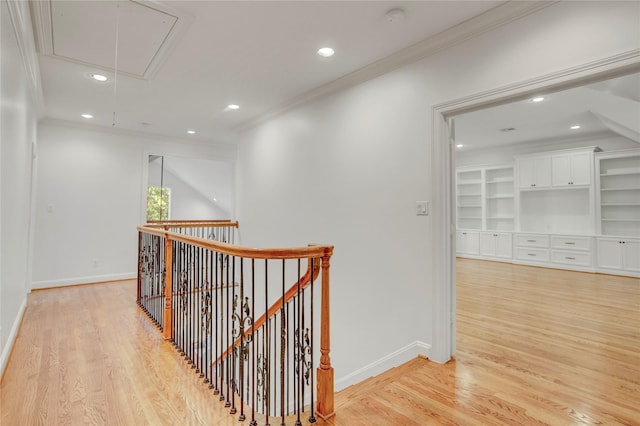 corridor featuring attic access, recessed lighting, ornamental molding, and an upstairs landing