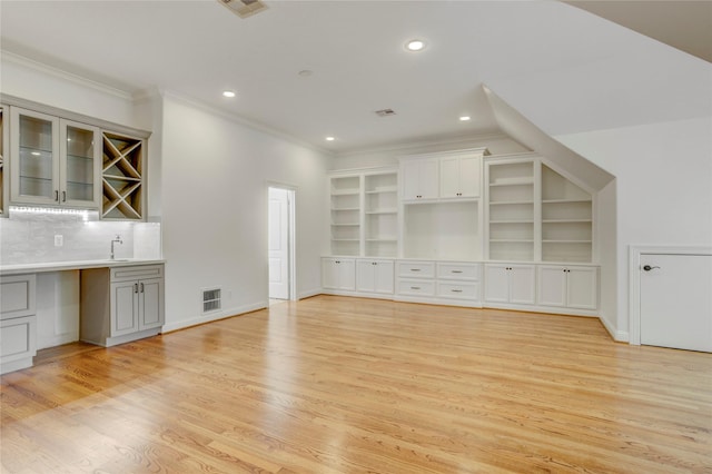 unfurnished living room featuring visible vents, recessed lighting, light wood-style floors, and ornamental molding
