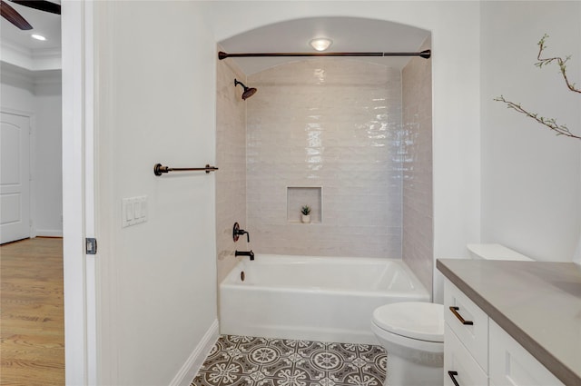 full bath with tile patterned floors, vanity, washtub / shower combination, baseboards, and toilet