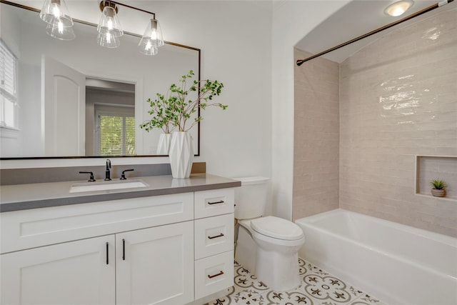 bathroom with tile patterned floors, vanity, shower / tub combination, and toilet