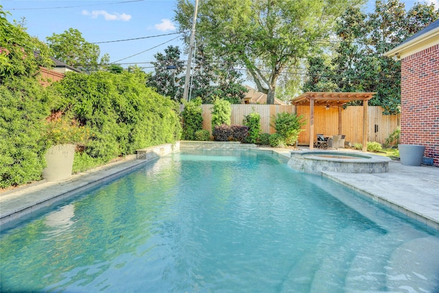 view of swimming pool with a pool with connected hot tub, a patio area, and a fenced backyard