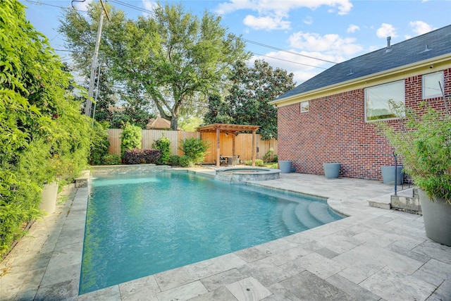 view of swimming pool featuring a patio area, a pool with connected hot tub, and a fenced backyard