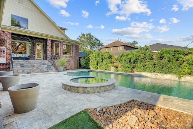 view of pool featuring a pool with connected hot tub and a patio
