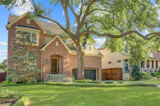 view of front of property with fence, brick siding, and a front yard