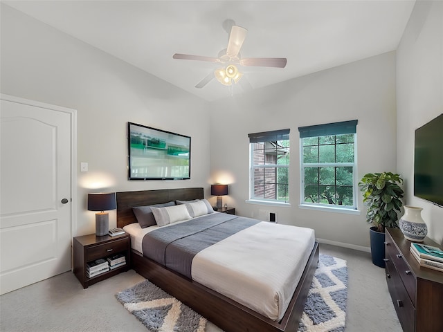 bedroom with ceiling fan, light carpet, and baseboards