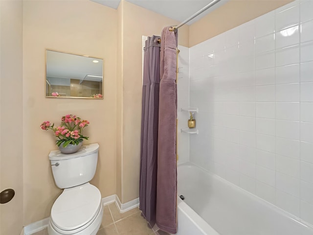 full bath featuring baseboards, tile patterned floors, shower / bath combo, and toilet