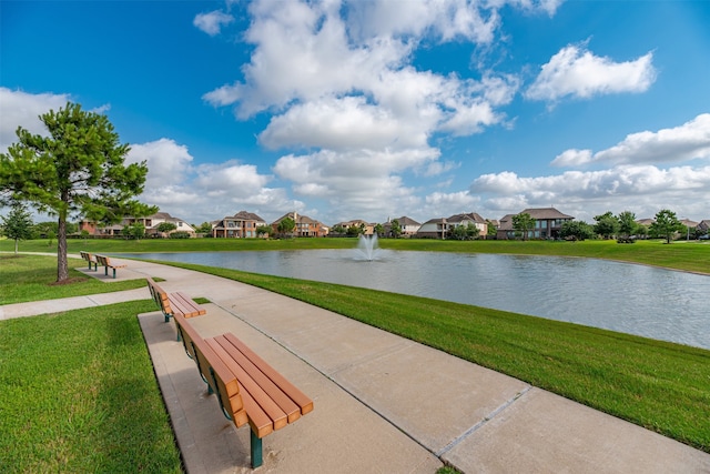 view of home's community featuring a lawn, a water view, and a residential view