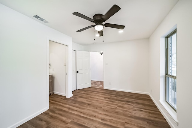 2742 Triway Ln, Houston, TX 77043 - unfurnished bedroom featuring visible vents, wood finished floors, baseboards, ensuite bathroom, and a ceiling fan