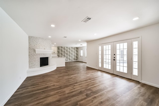 2742 Triway Ln, Houston, TX 77043 - unfurnished living room featuring dark wood-style flooring, a fireplace with raised hearth, recessed lighting, baseboards, and visible vents