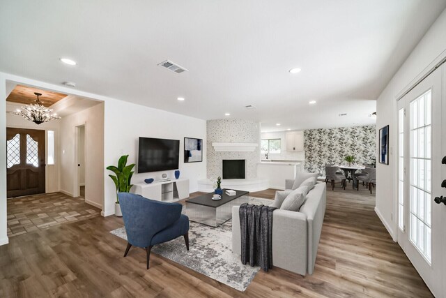 2742 Triway Ln, Houston, TX 77043 - living room featuring a chandelier, visible vents, recessed lighting, and light wood-style floors