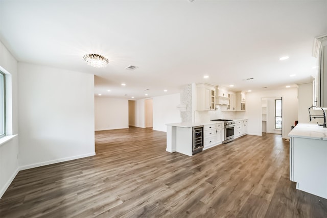2742 Triway Ln, Houston, TX 77043 - kitchen featuring dark wood-style flooring, high end stainless steel range oven, visible vents, light countertops, and open floor plan