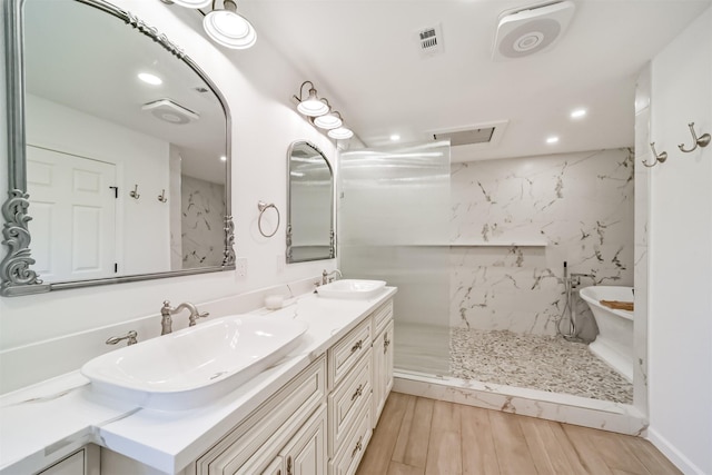 2742 Triway Ln, Houston, TX 77043 - full bath featuring a sink, double vanity, recessed lighting, and wood finished floors