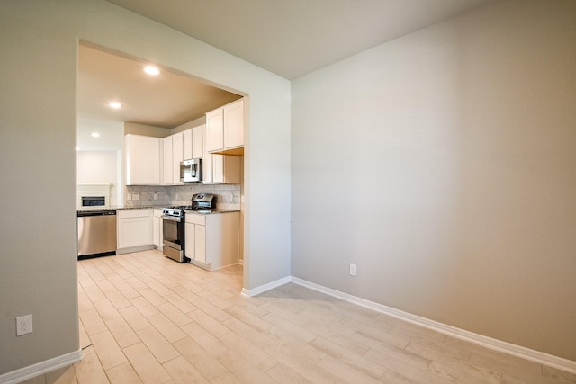 2103 Islawild Way, Texas City, TX 77568 - kitchen featuring appliances with stainless steel finishes, backsplash, recessed lighting, white cabinetry, and dark stone countertops